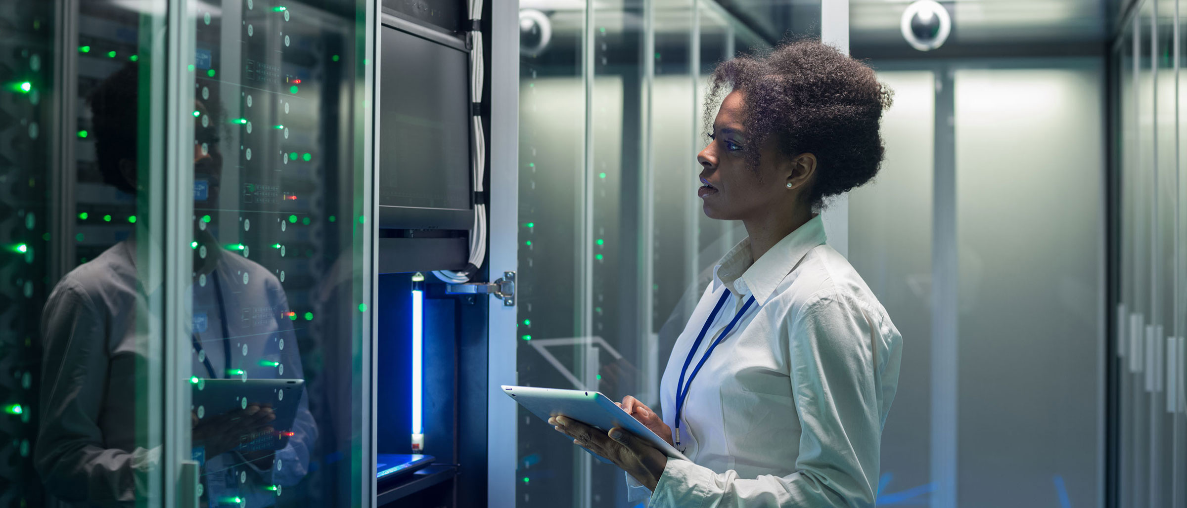 Woman in server room looking at screen