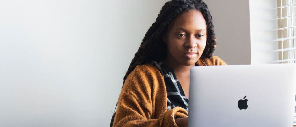 Woman using MacBook laptop