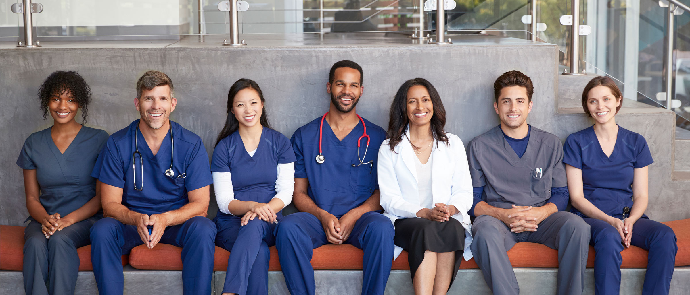 Team of healthcare workers seated on bench