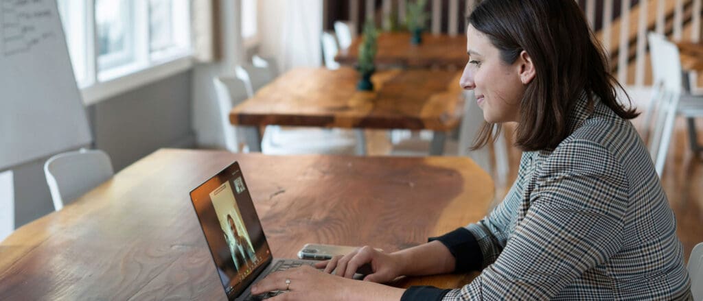 Woman video calling man on laptop