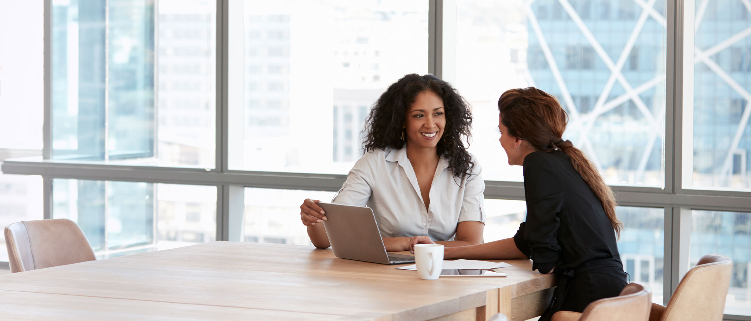 Two women in a meeting - contract staffing