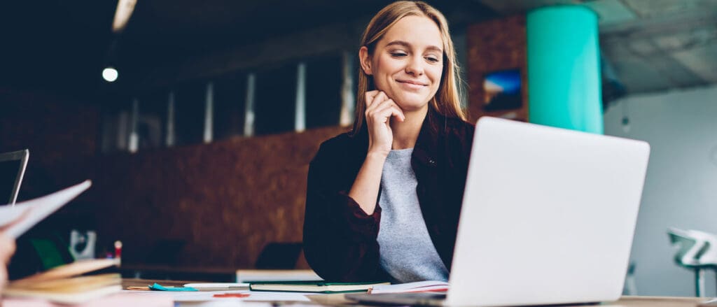 Woman smiling at laptop