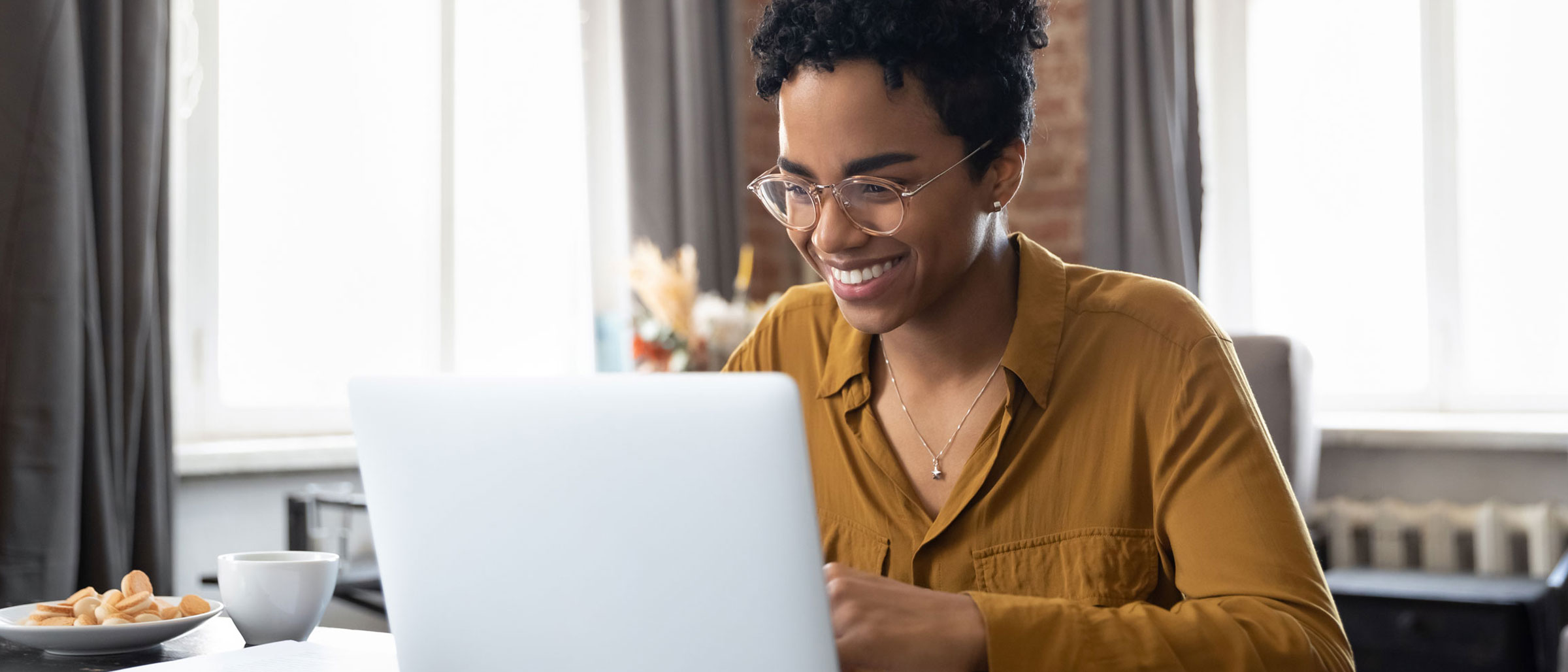 Woman smiling at laptop screen