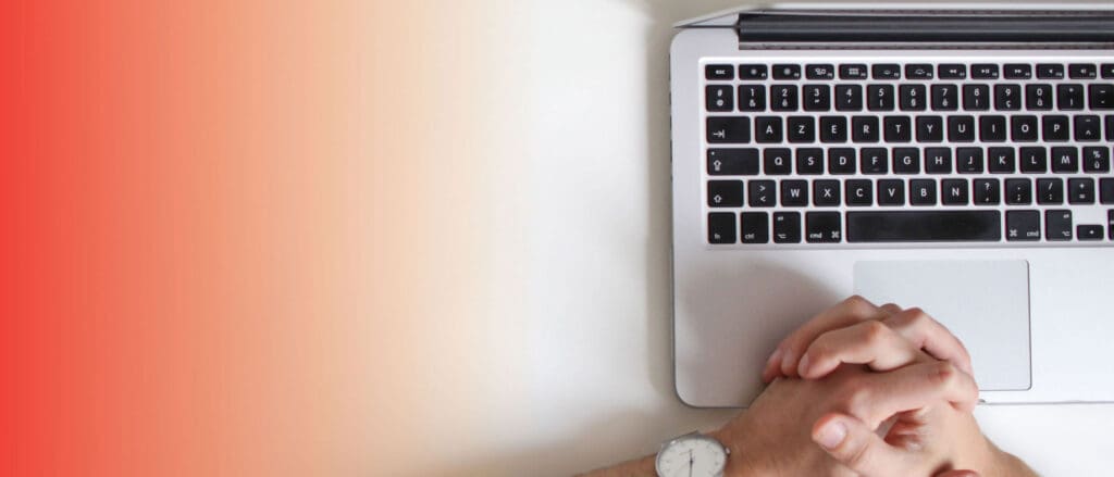 Person folding hands on laptop