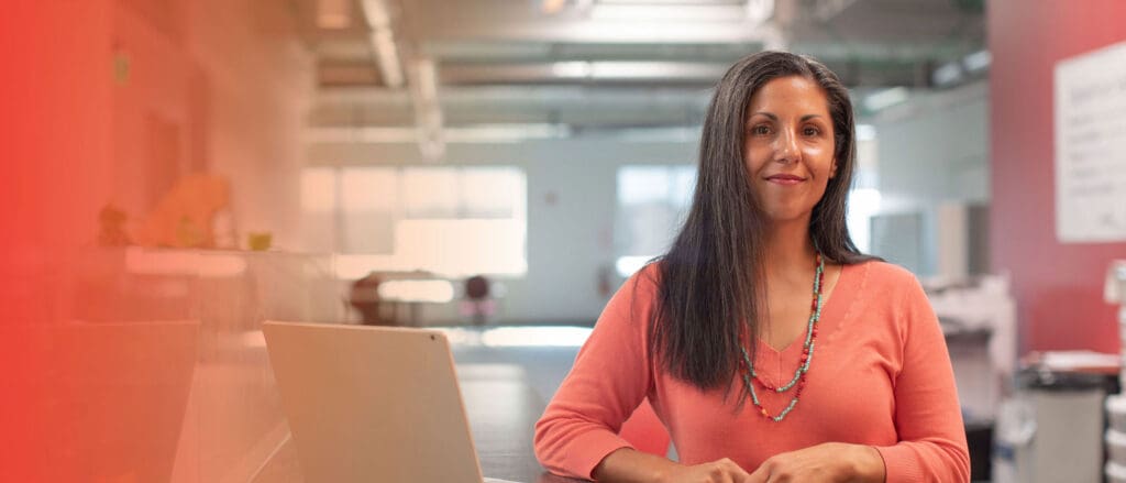 Woman smiling at camera in office setting