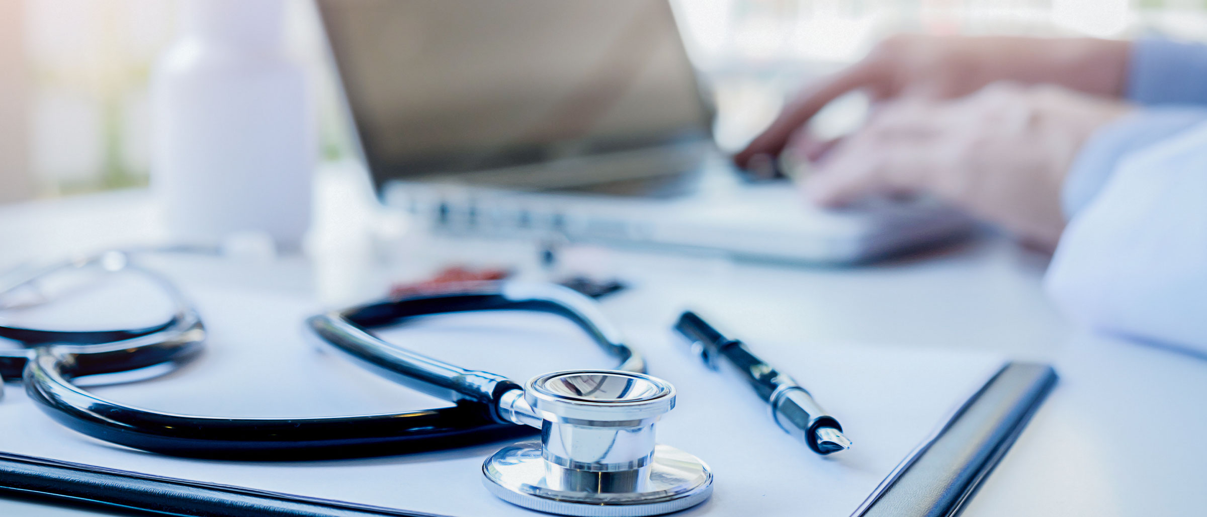 Stethoscope on desk next to laptop