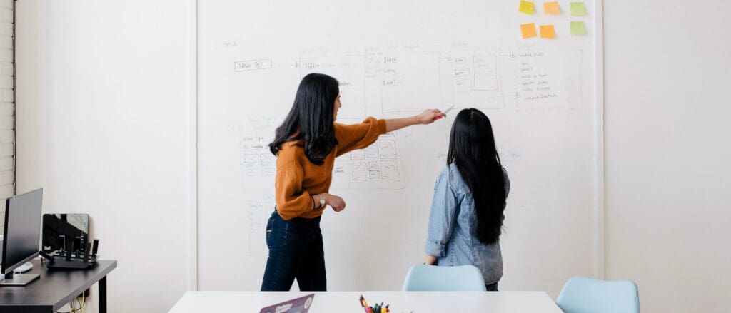 Learning and Development Recruiter pointing to a whiteboard