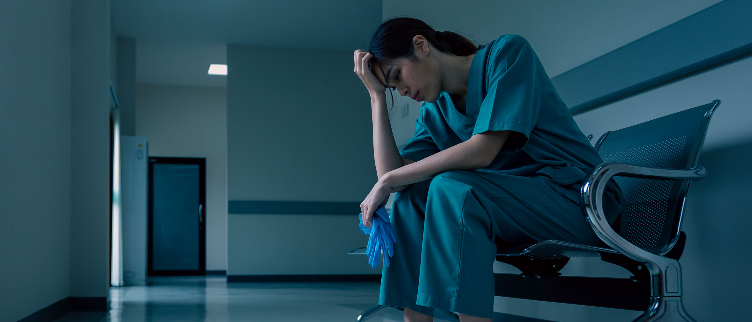 Tired Nurse sitting on hospital bench