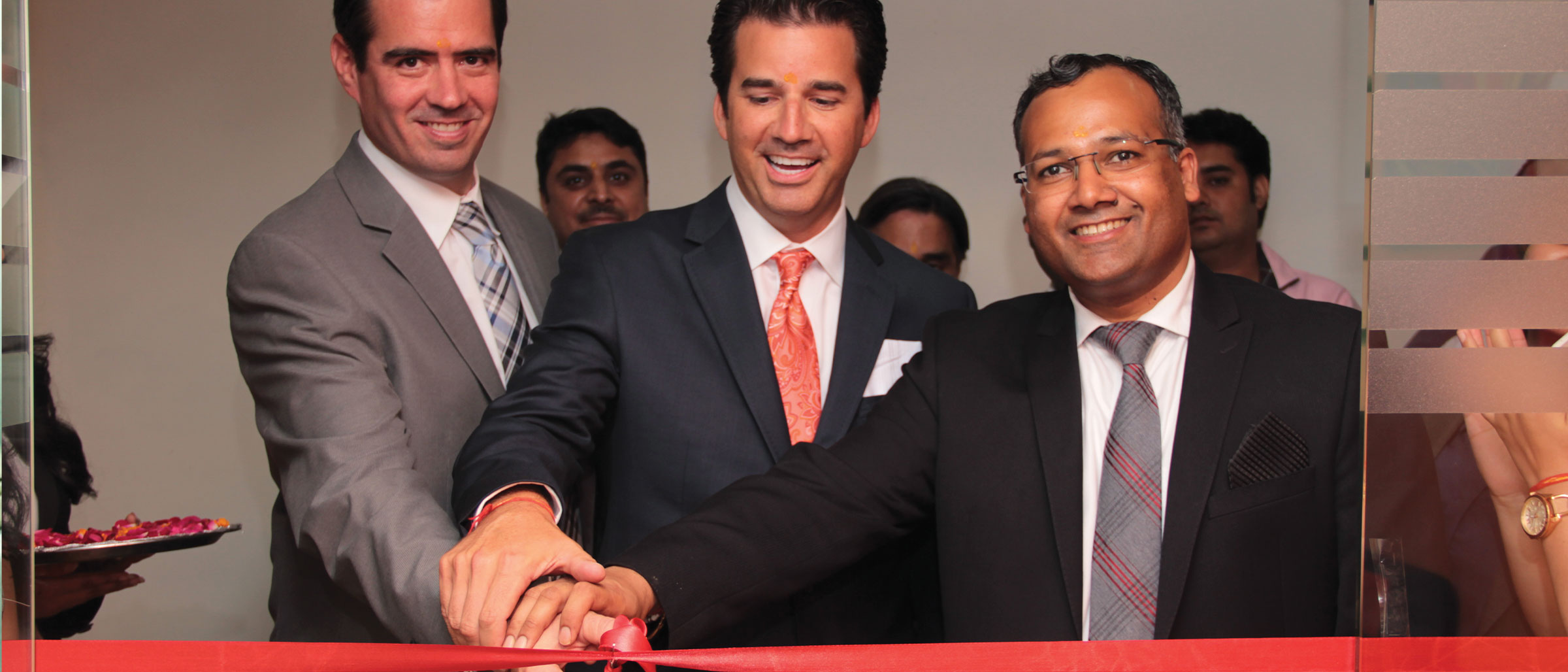 Martin Judge III, Brian Anderson, and Abihshek Agarwal cutting ceremonial ribbon