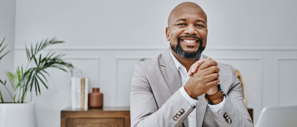 Man smiling with hands folded