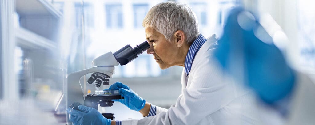 Scientist looking in microscope