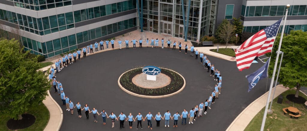 Judge Group Employees circled around HQ sign