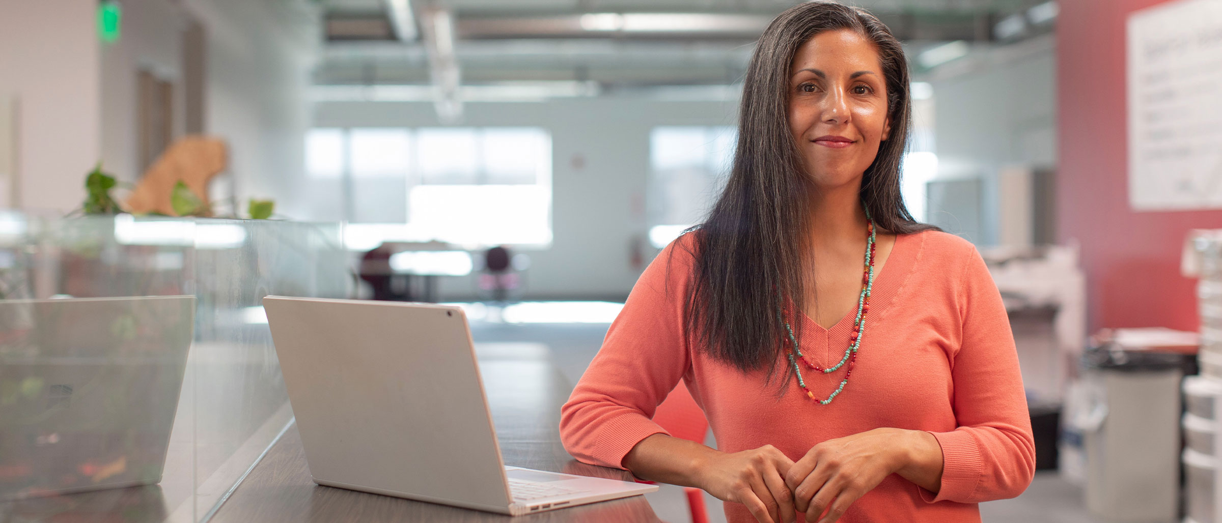 HR Professional standing next to laptop