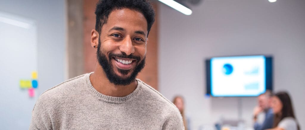 Man smiling in board room