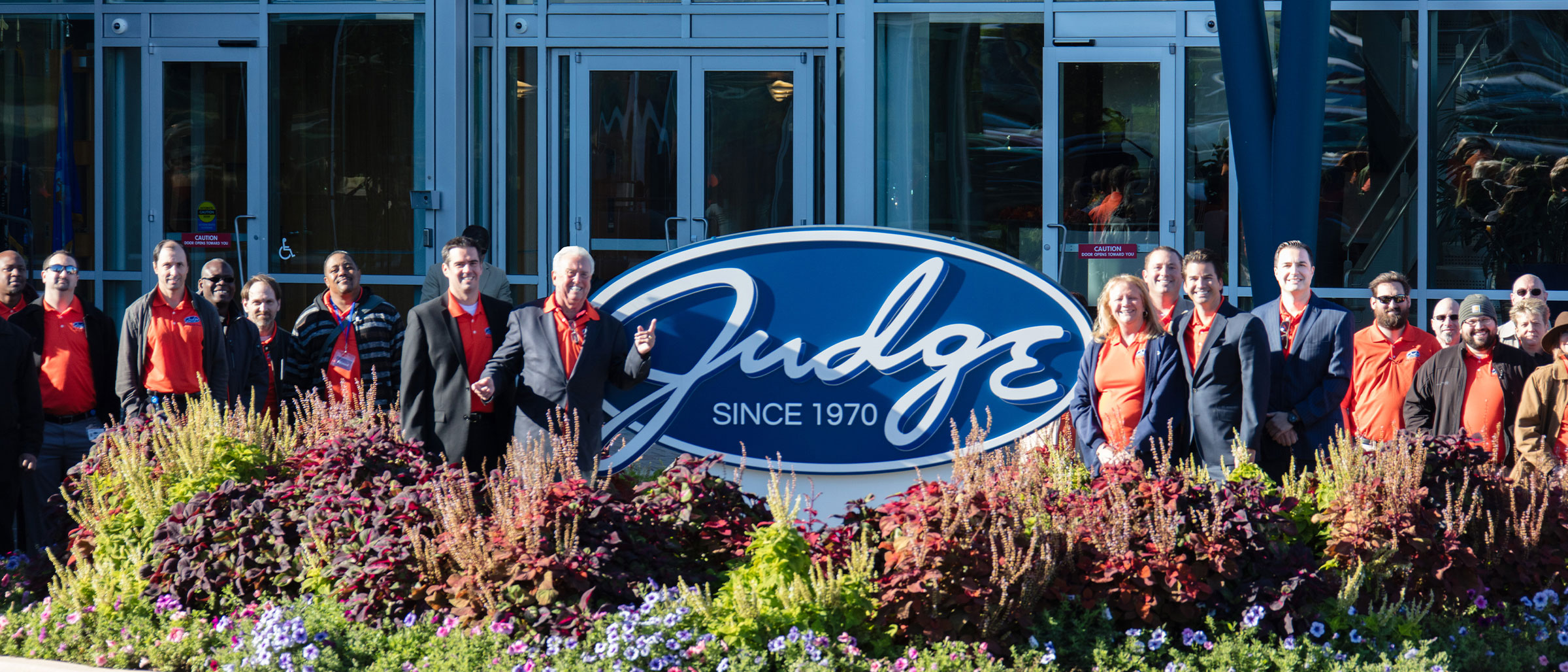 Judge Group Team standing in front of Judge Building