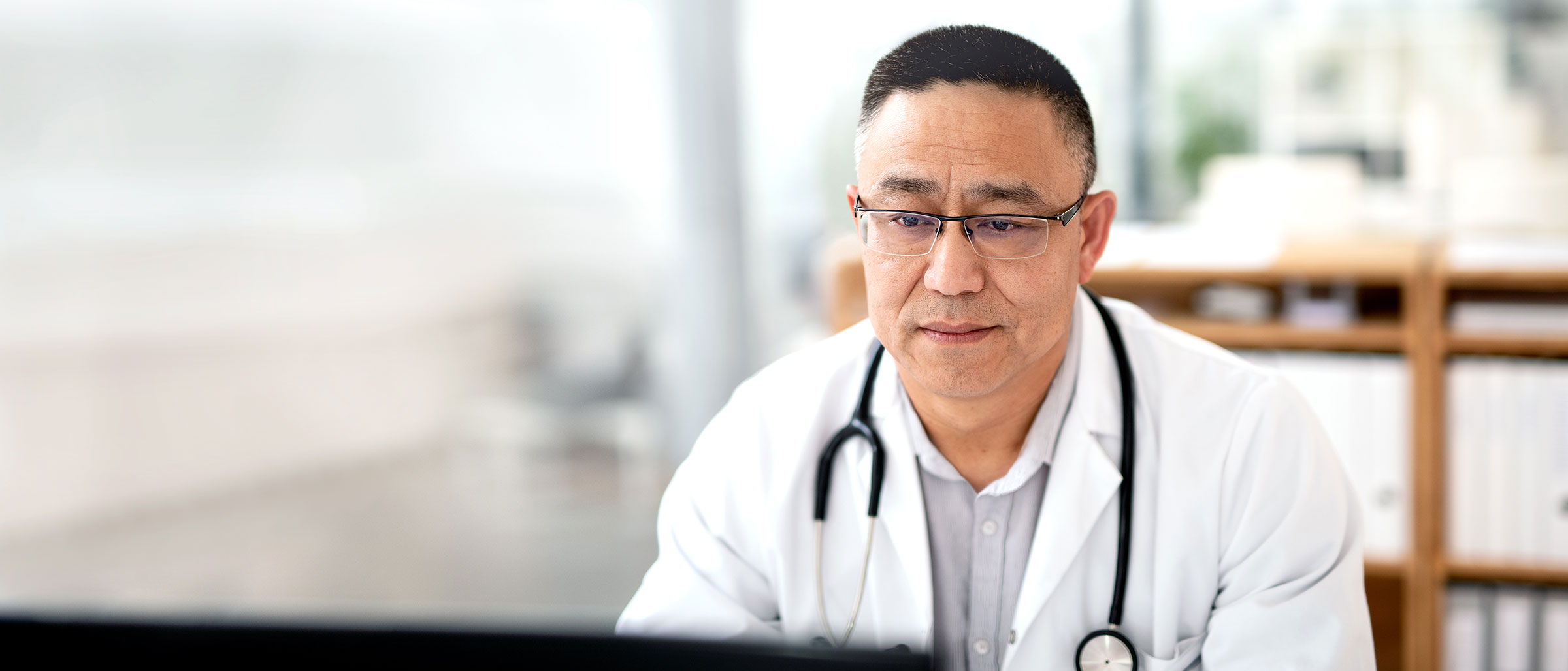 Medical Professional looking at computer screen