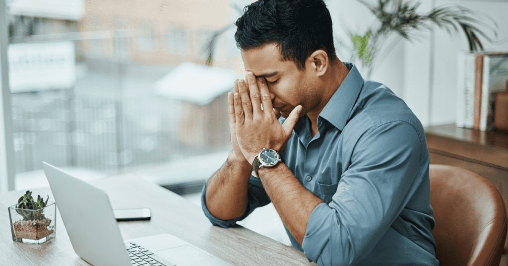 Man holding hands on face, stressed