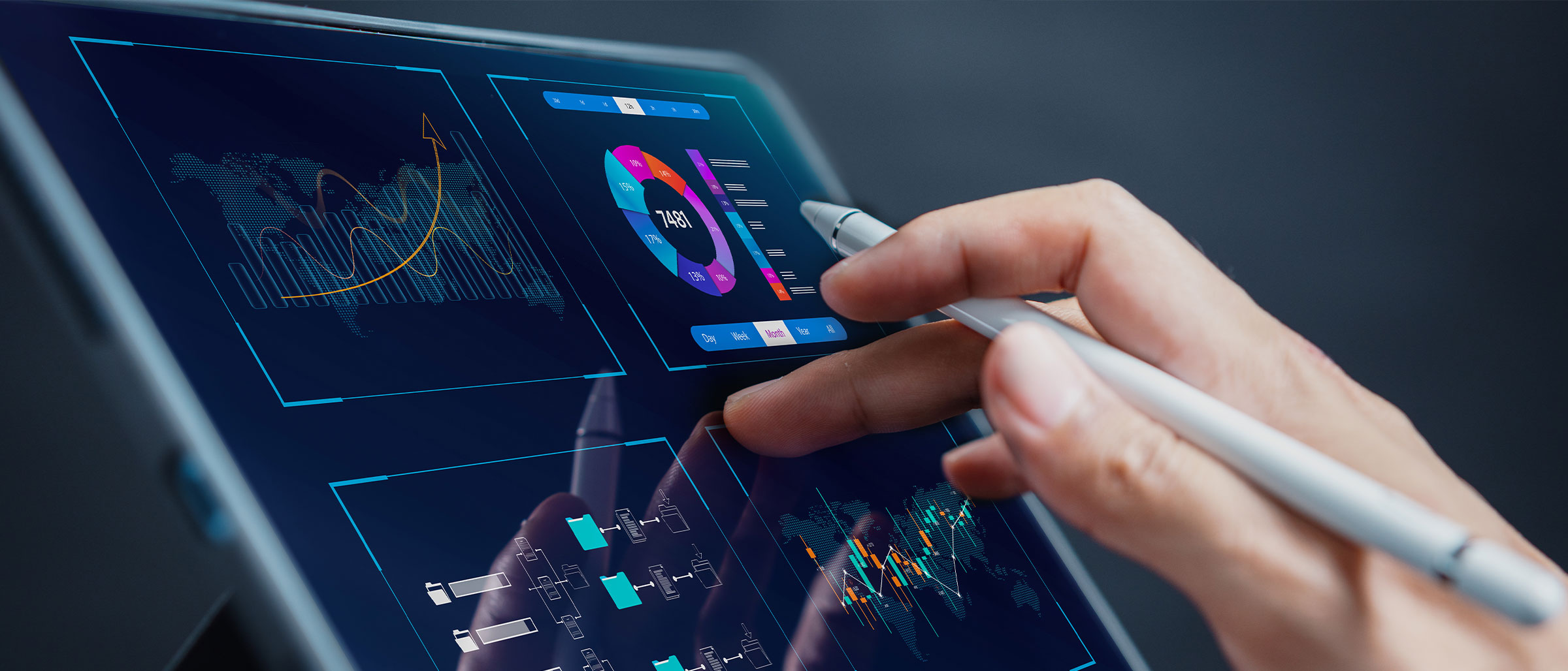 A hand holding a tablet with graphs and charts on it