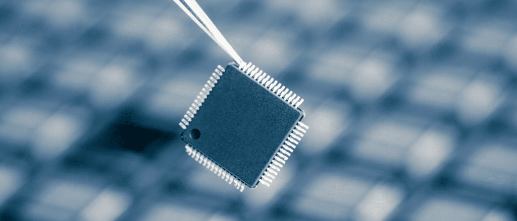 Computer Processor being held by tweezers