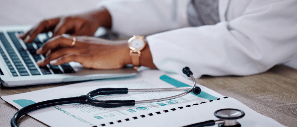 Medical Professional typing on laptop