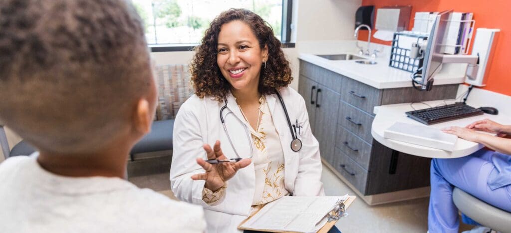 Primary Care Doctor Assisting Child