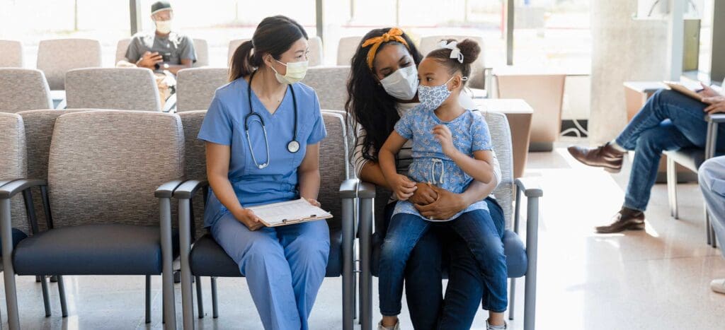 Urgent Care Specialist Sitting Next to Patient