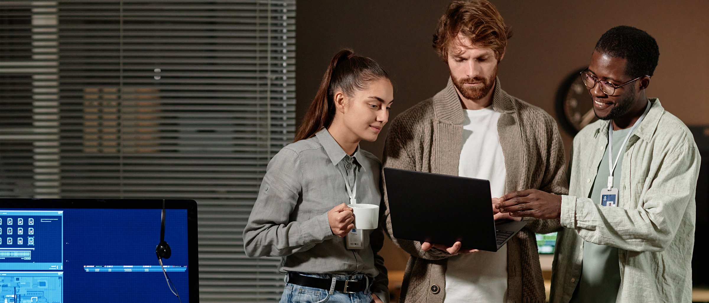 Group of IT professionals working together on laptop