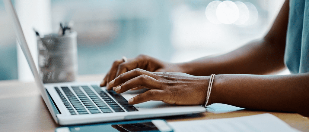 Person typing on macbook