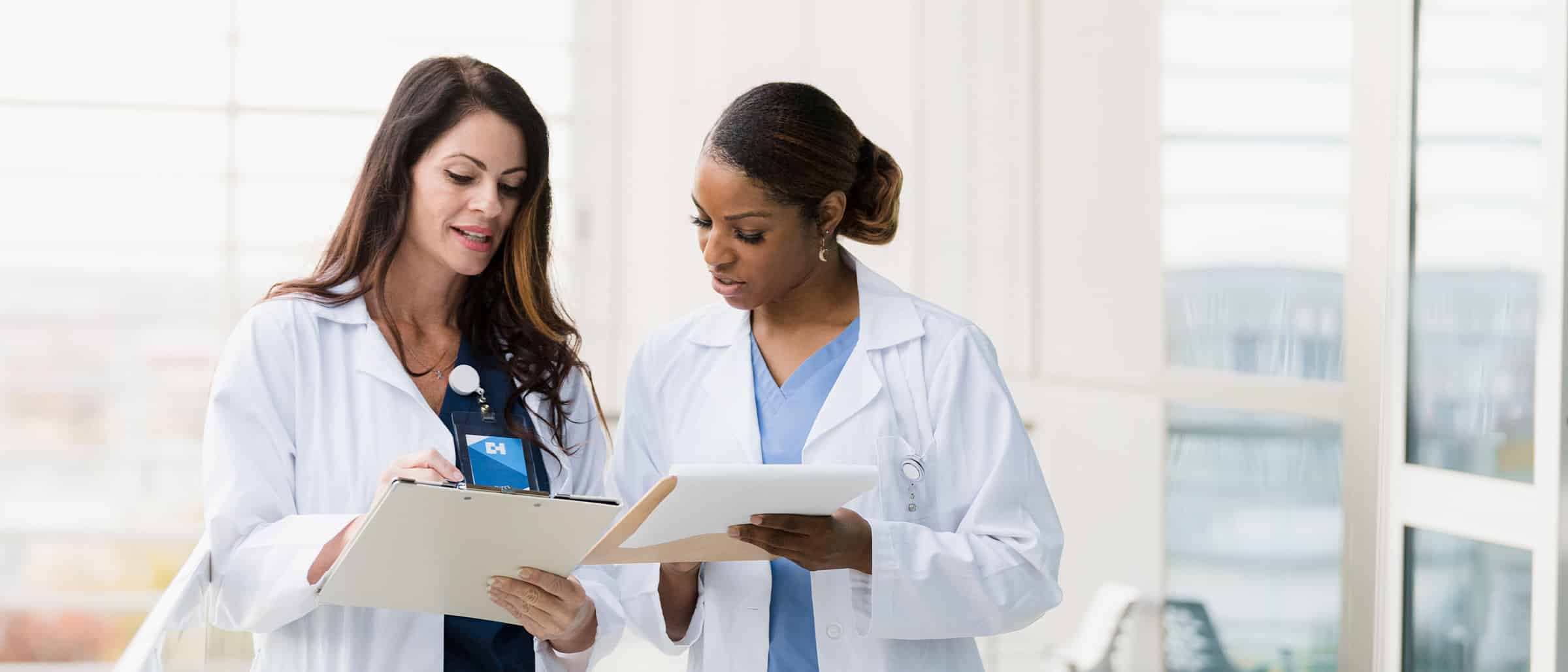 Healthcare workers looking at clipboard with papers