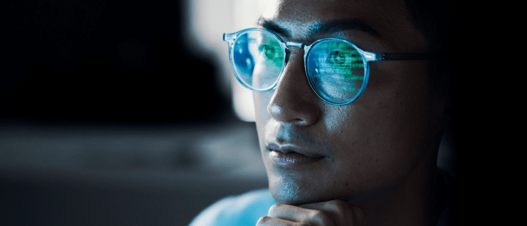 Cybersecurity Specialist with code reflecting in glasses