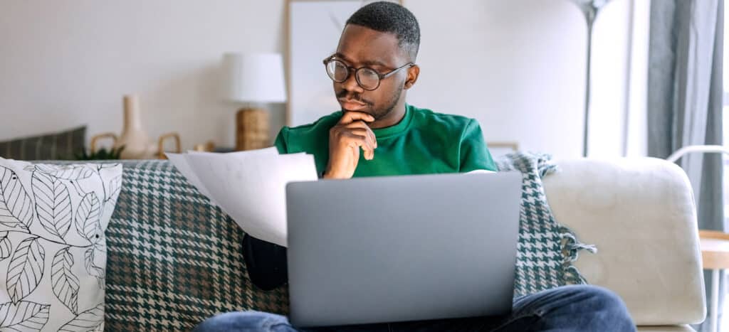 Man looking for jobs on laptop