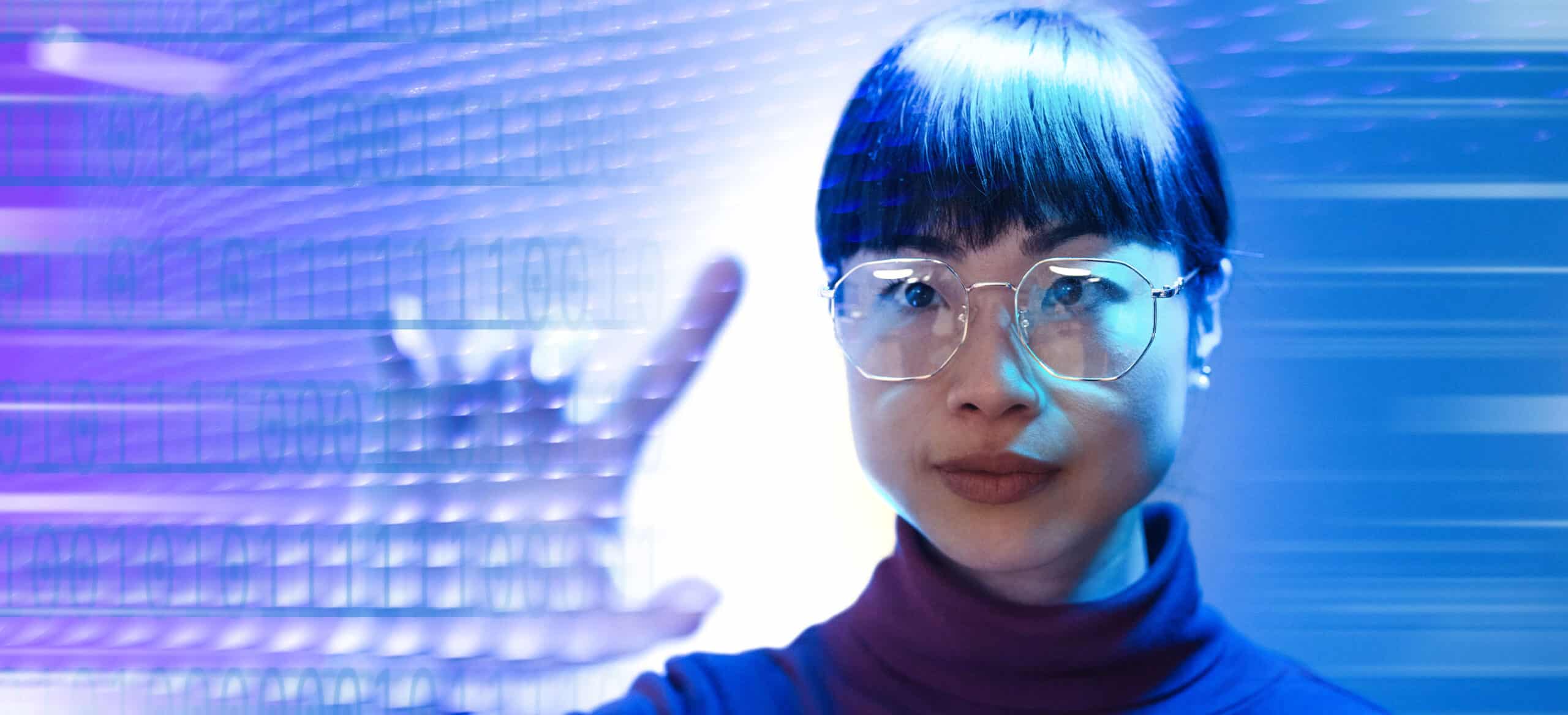 Woman pointing at screen with 1's and 0's