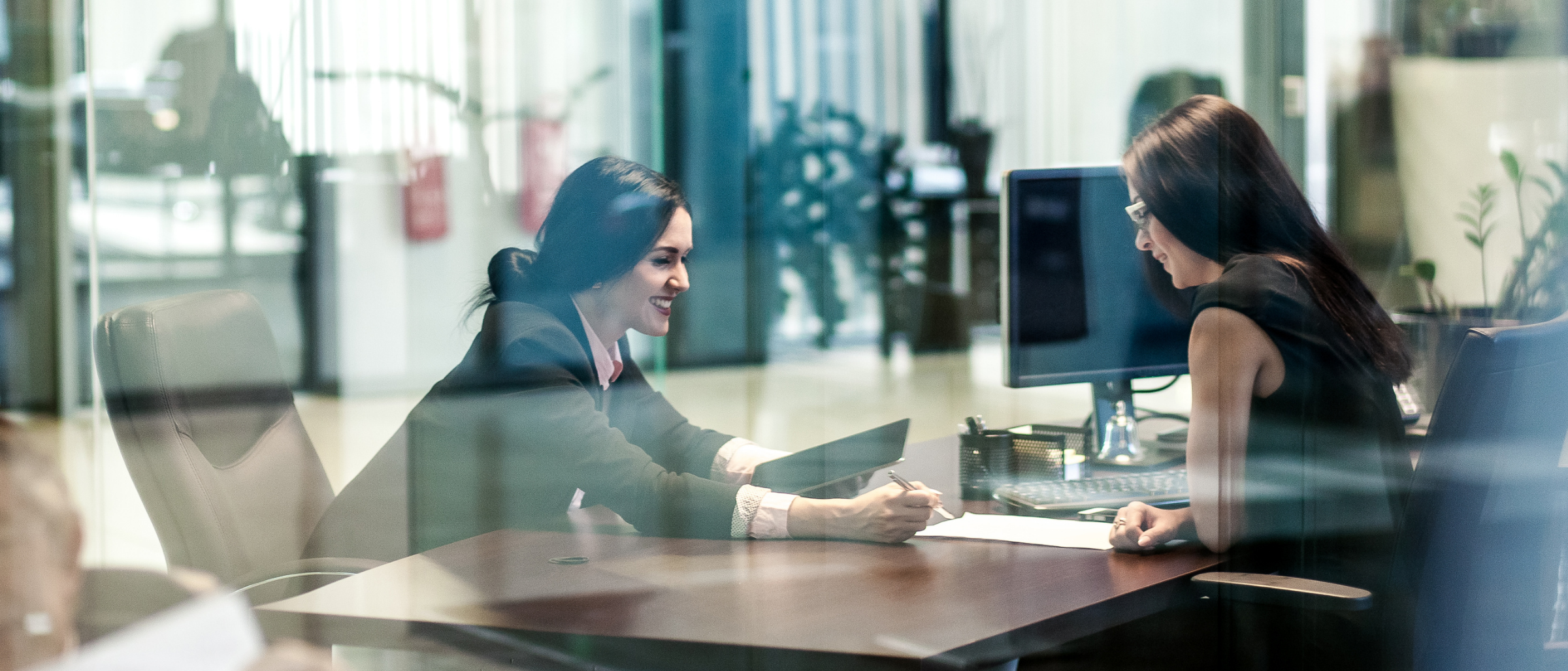 Two women sitting at office desk