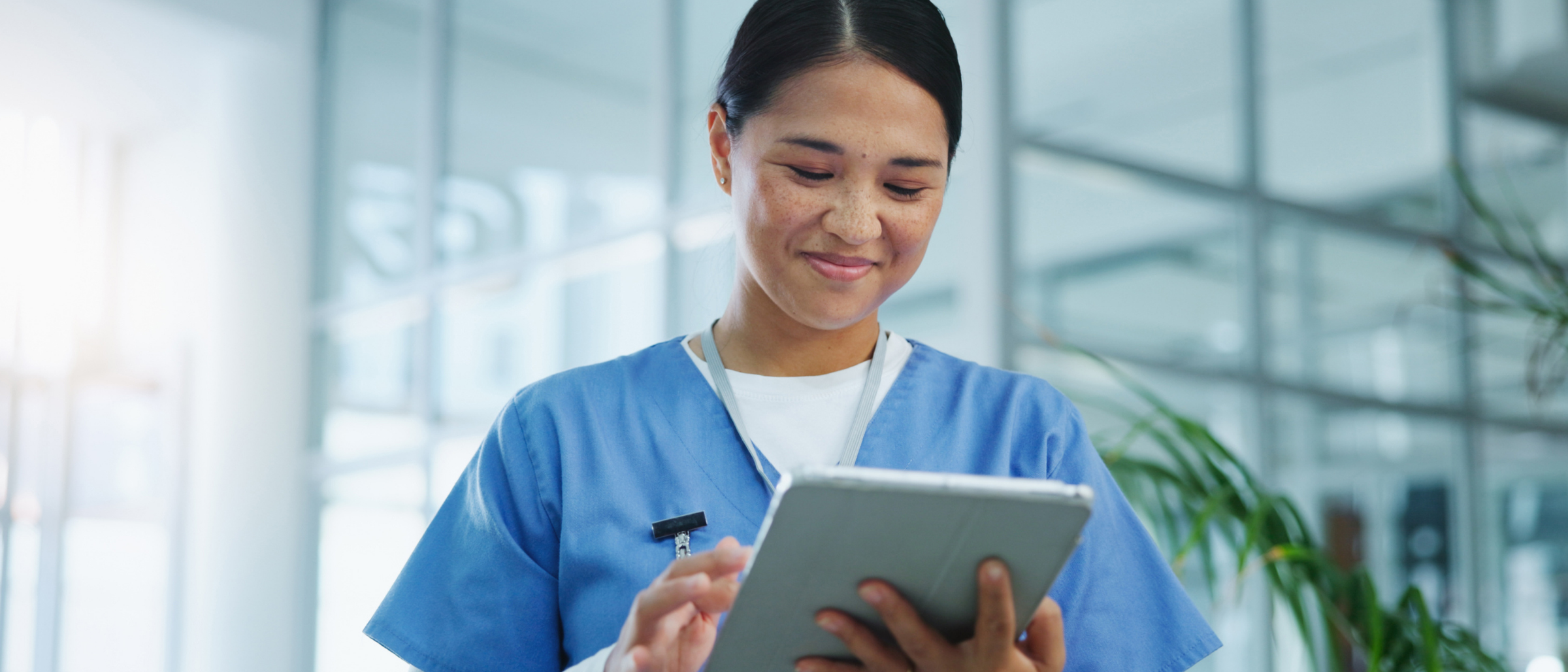 Female medical professional looking at results on tablet