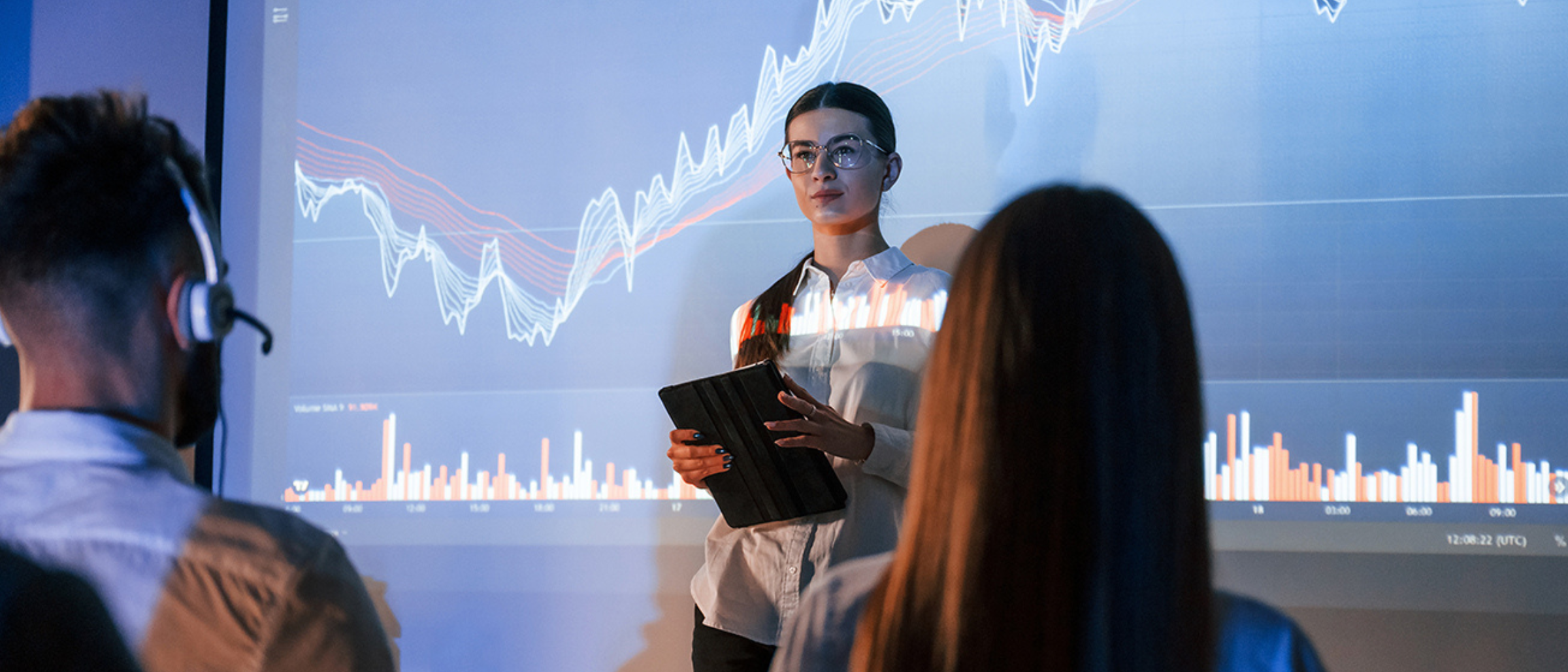 Image of a woman in front of data visualizations