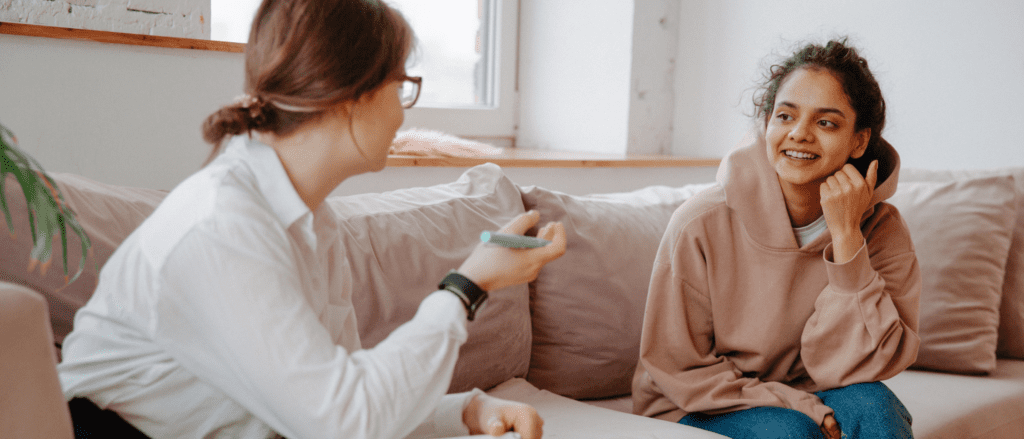 Two women talking on couch