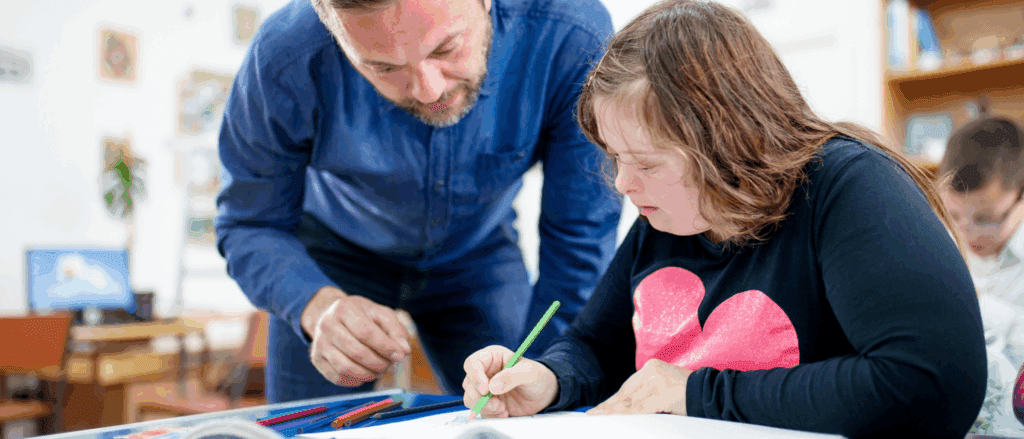 Teacher assisting a special needs student