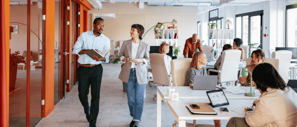 Open space office featuring various employees at desks or walking through the space