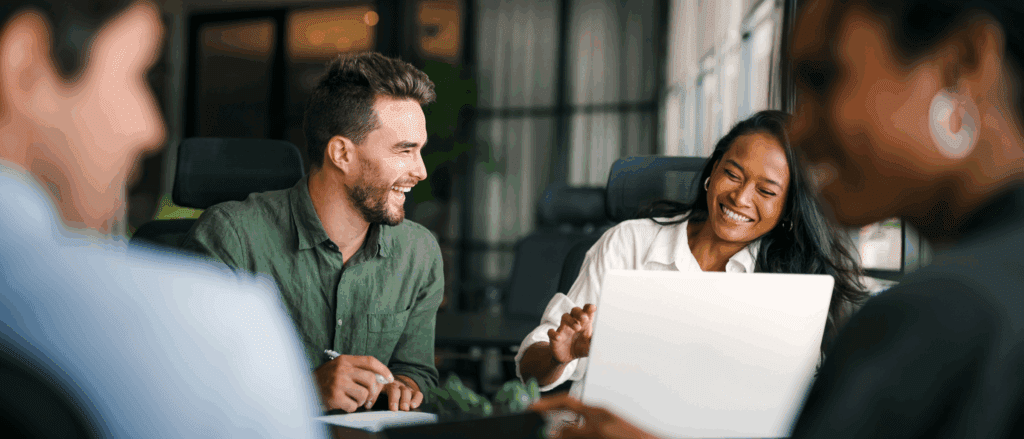 Group of coworkers laughing and collaborating