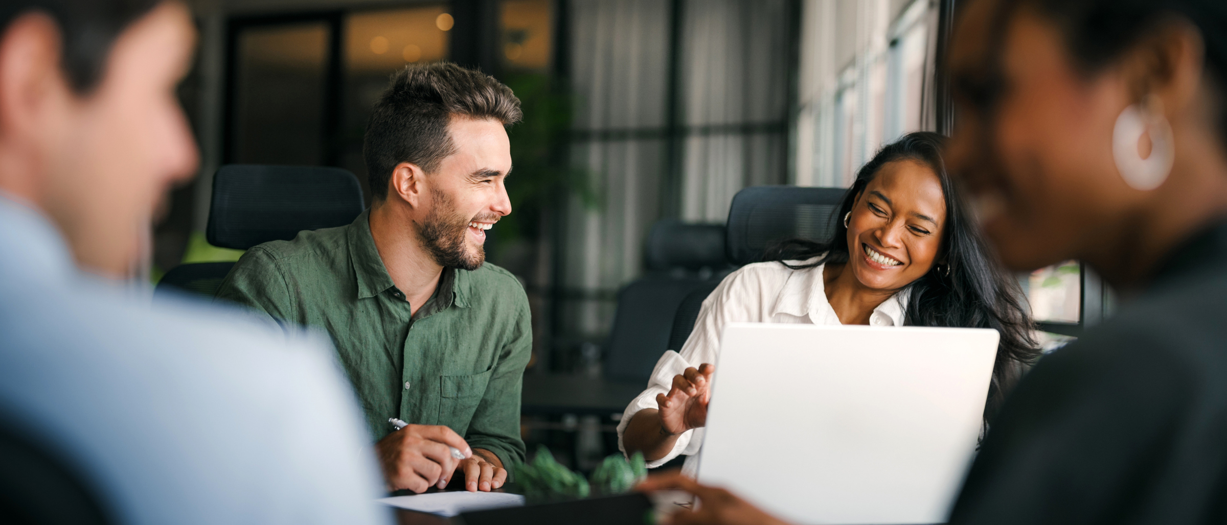 Group of coworkers laughing and collaborating