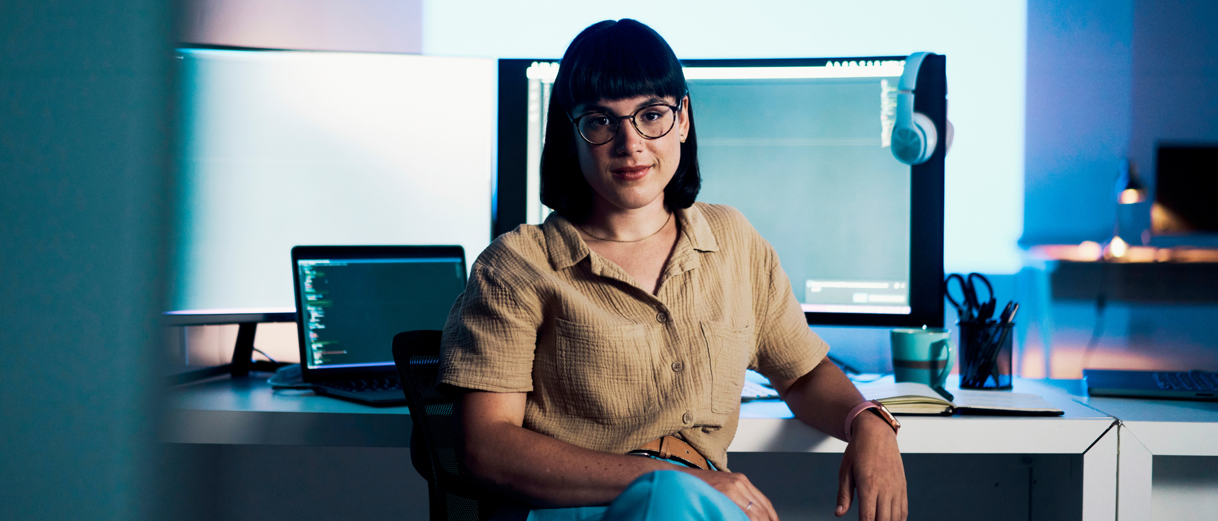 Woman seated in front of computer screens