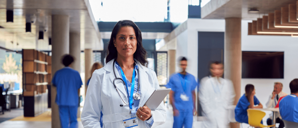 Physician with other healthcare workers off in the background