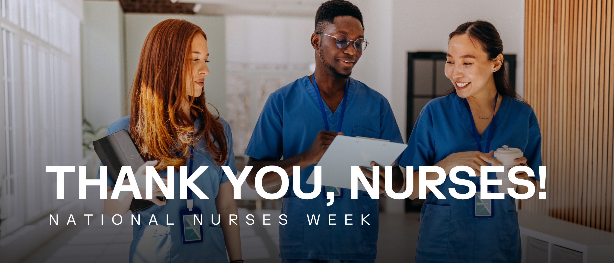Three nurses walking down a hall
