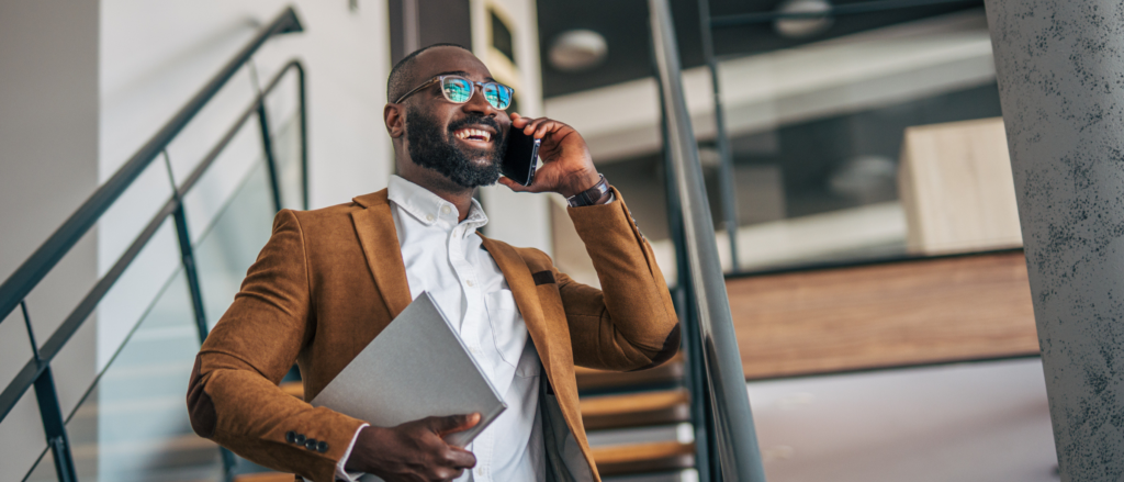 Account Executive on the phone walking in a commercial building