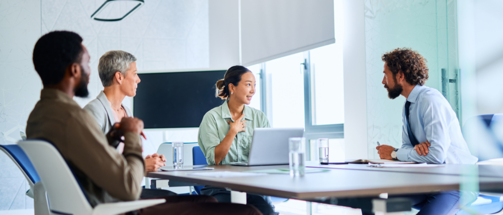 Group of professionals sitting around a conference table