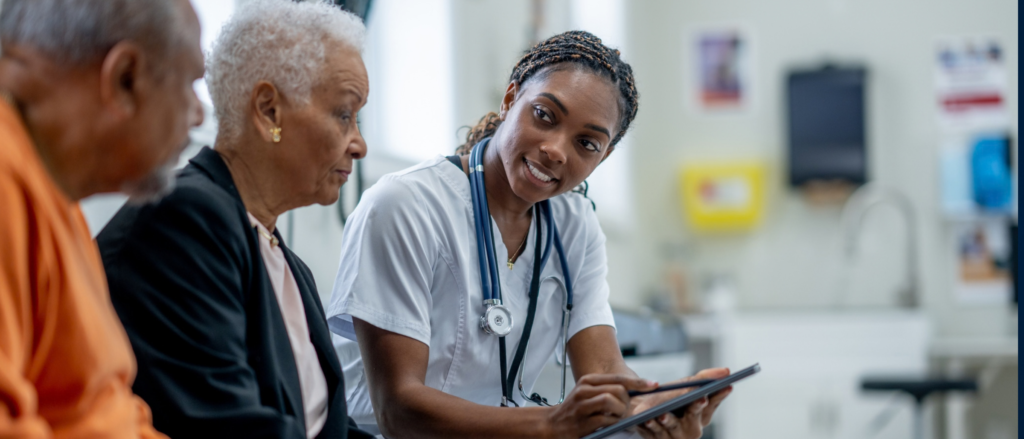 Medical professional speaking with a patient and a loved one in a medical setting